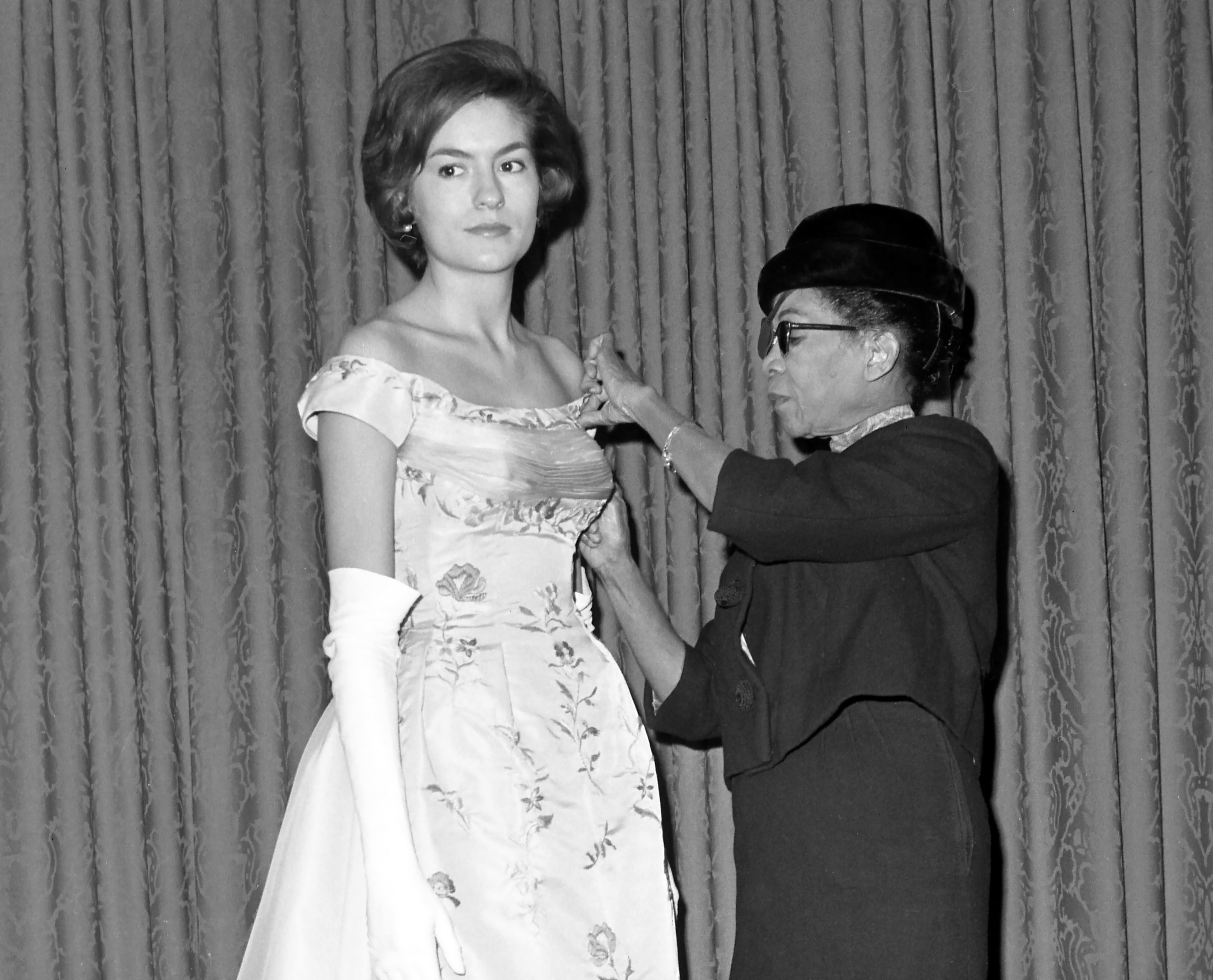 Ann Lowe adjusting the bodice of a gown, 1962